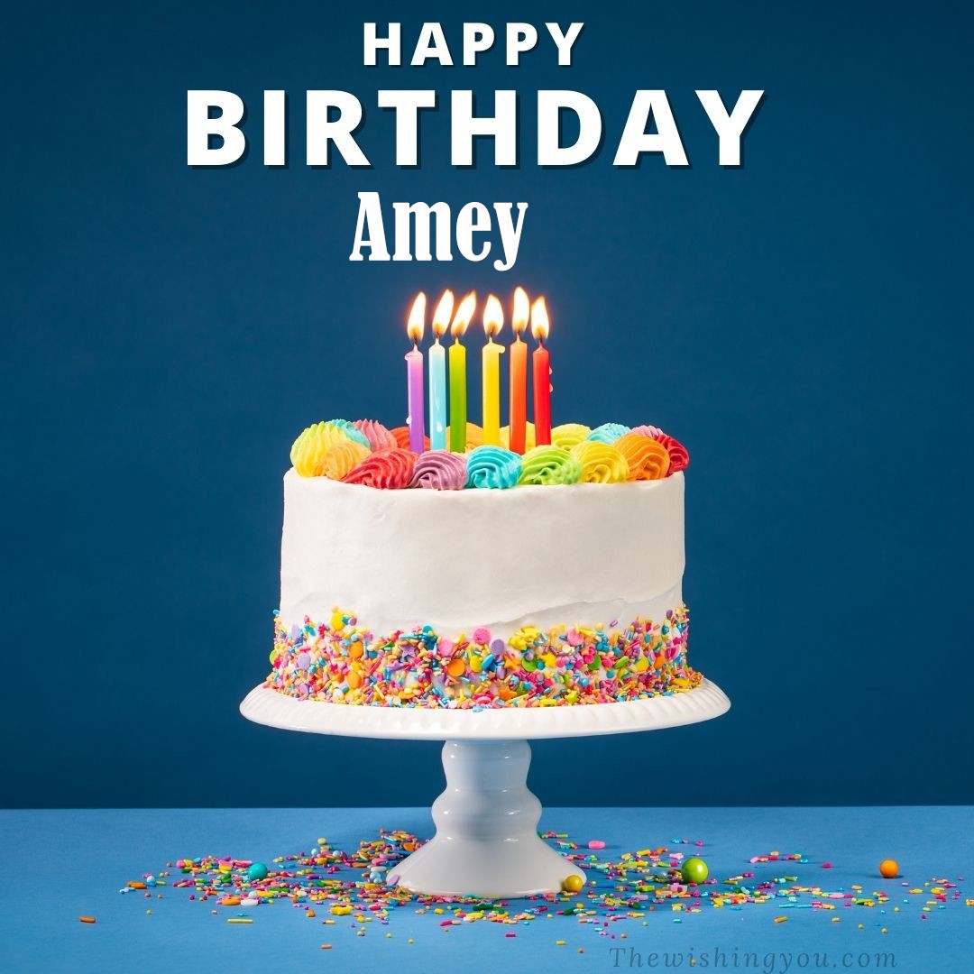 Happy birthday Amey written on image White cake keep on White stand and burning candles Sky background
