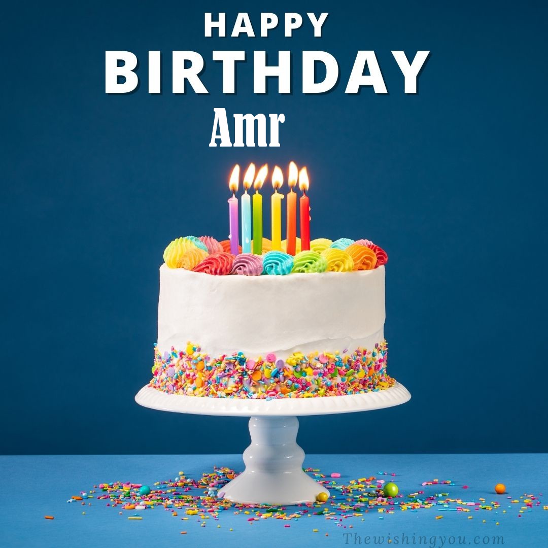 Happy birthday Amr written on image White cake keep on White stand and burning candles Sky background