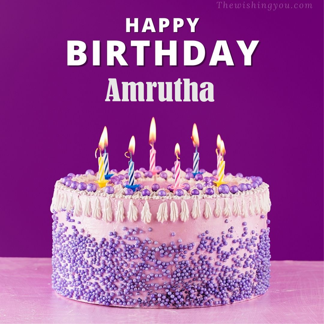 Happy birthday Amrutha written on image White and blue cake and burning candles Violet background