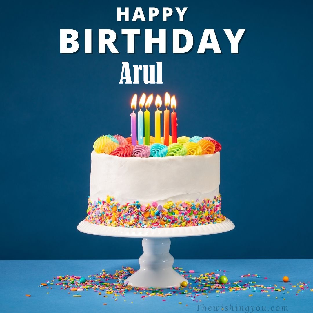 Happy birthday Arul written on image White cake keep on White stand and burning candles Sky background