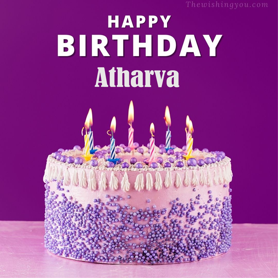 Happy birthday Atharva written on image White and blue cake and burning candles Violet background
