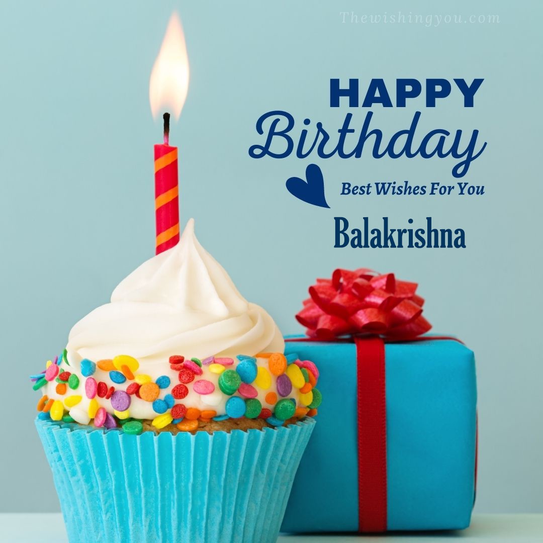 Happy birthday Balakrishna written on image Blue Cup cake and burning candle blue Gift boxes with red ribon