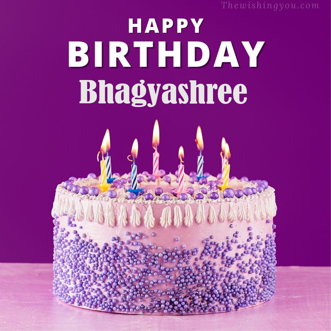 Happy birthday Bhagyashree written on image White and blue cake and burning candles Violet background