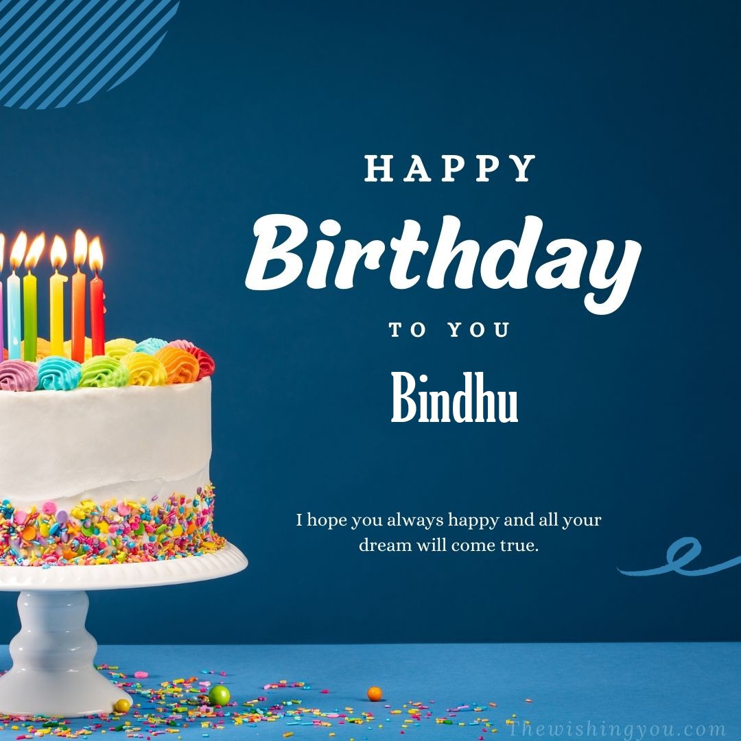 Happy birthday Bindhu written on image white cake and burning candle Blue Background
