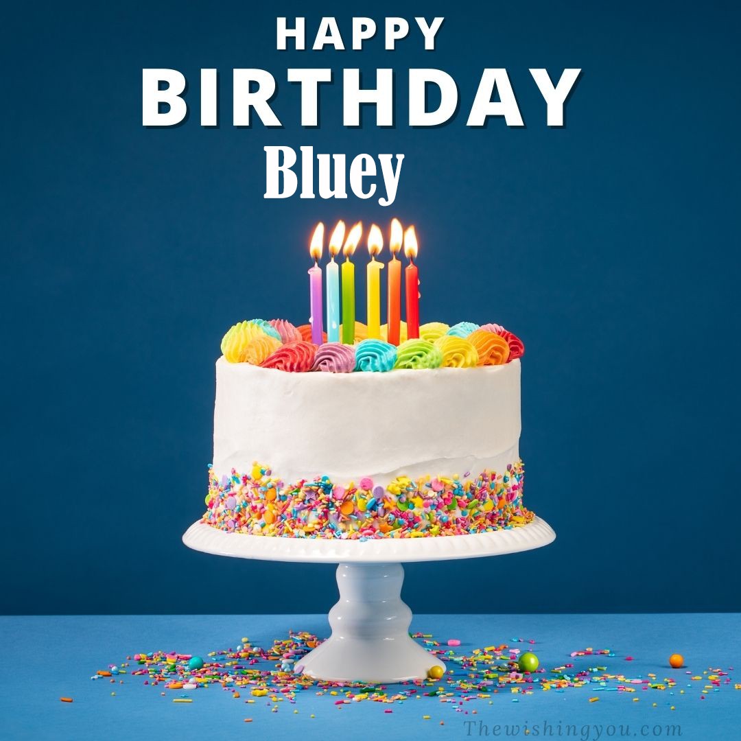 Happy birthday Bluey written on image White cake keep on White stand and burning candles Sky background