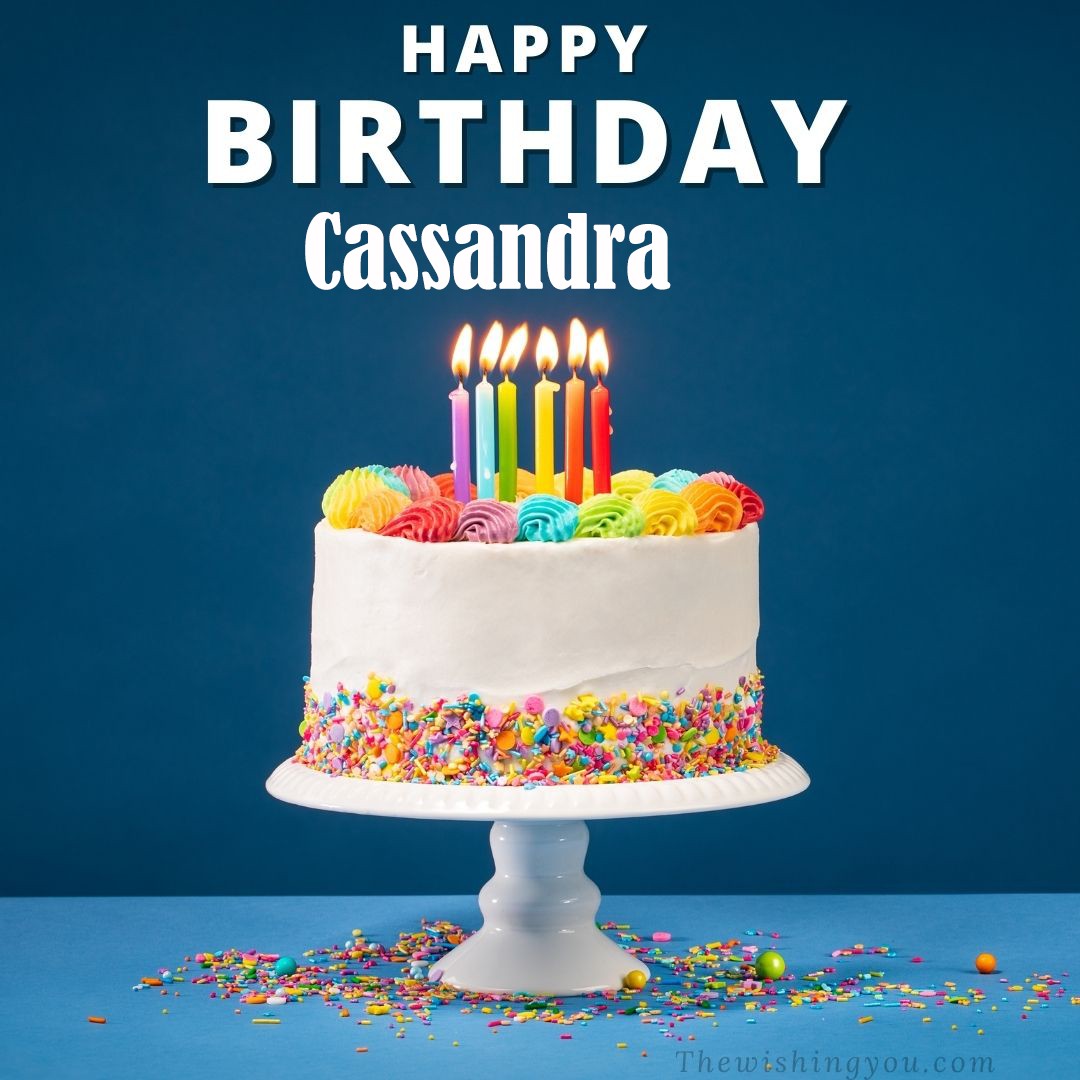 Happy birthday Cassandra written on image White cake keep on White stand and burning candles Sky background