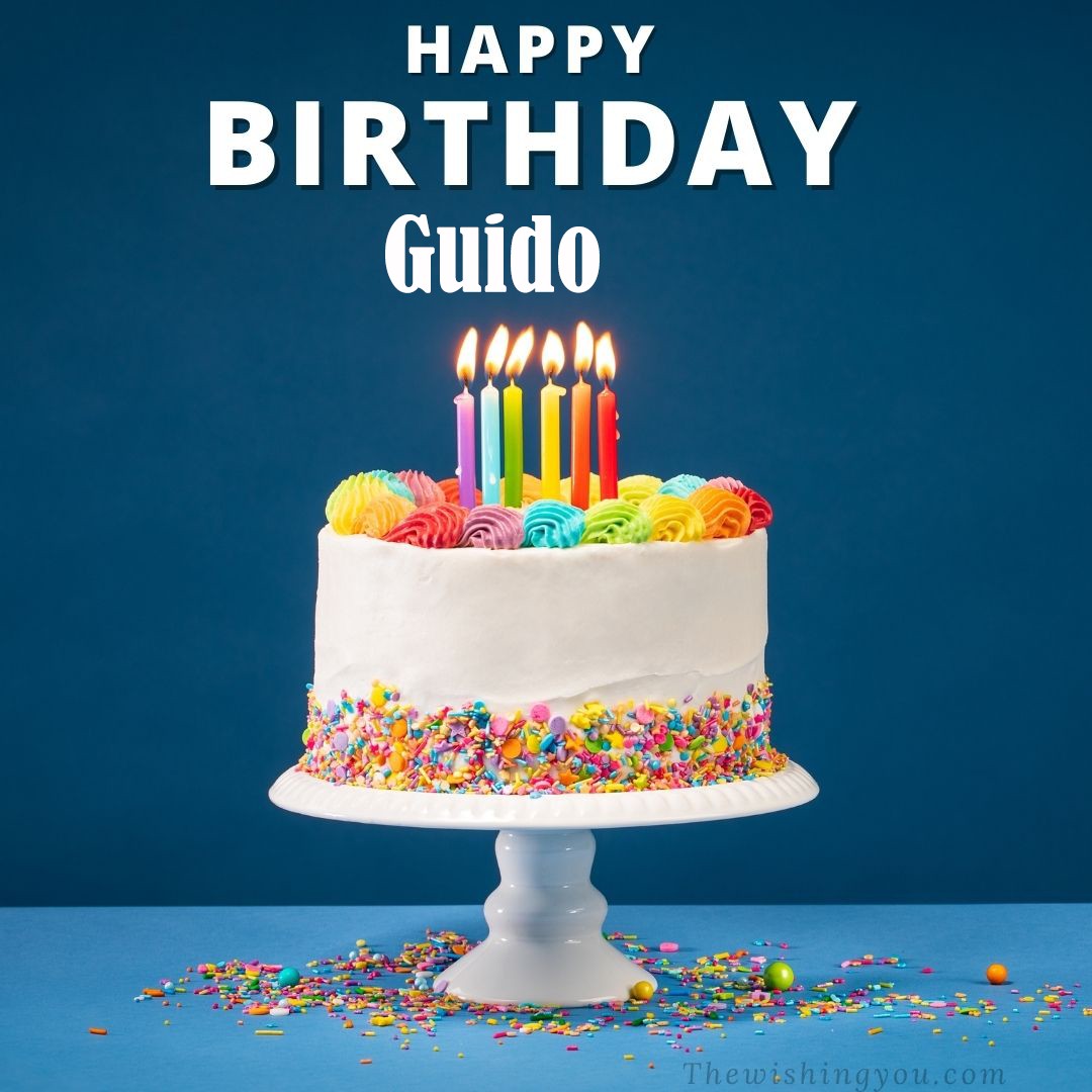 Happy birthday Guido written on image White cake keep on White stand and burning candles Sky background