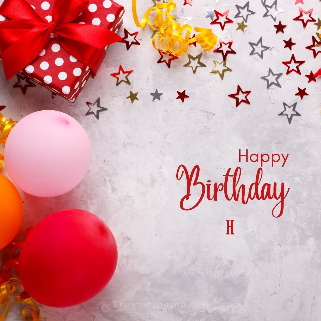 Happy birthday H written on image red gift boxes with red ribon and star and ballons
