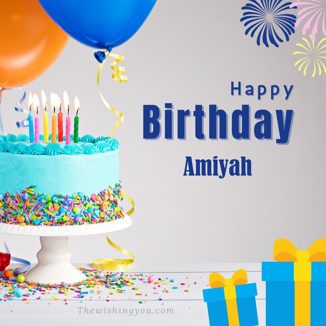 Happy Birthday Amiyah written on image Green cake keep on White stand and blue gift boxes with Yellow ribon with Sky background