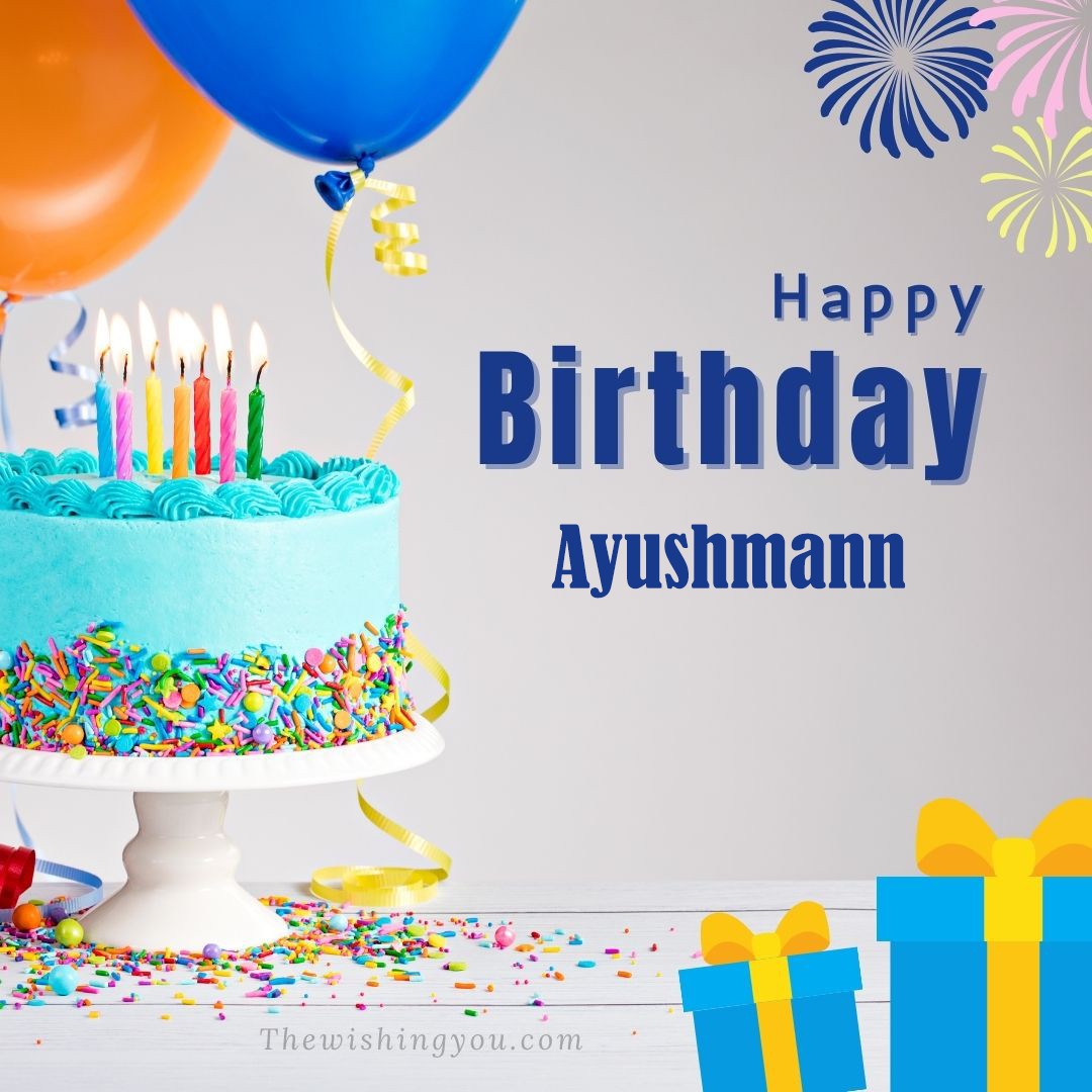 Happy Birthday Ayushmann written on image Green cake keep on White stand and blue gift boxes with Yellow ribon with Sky background