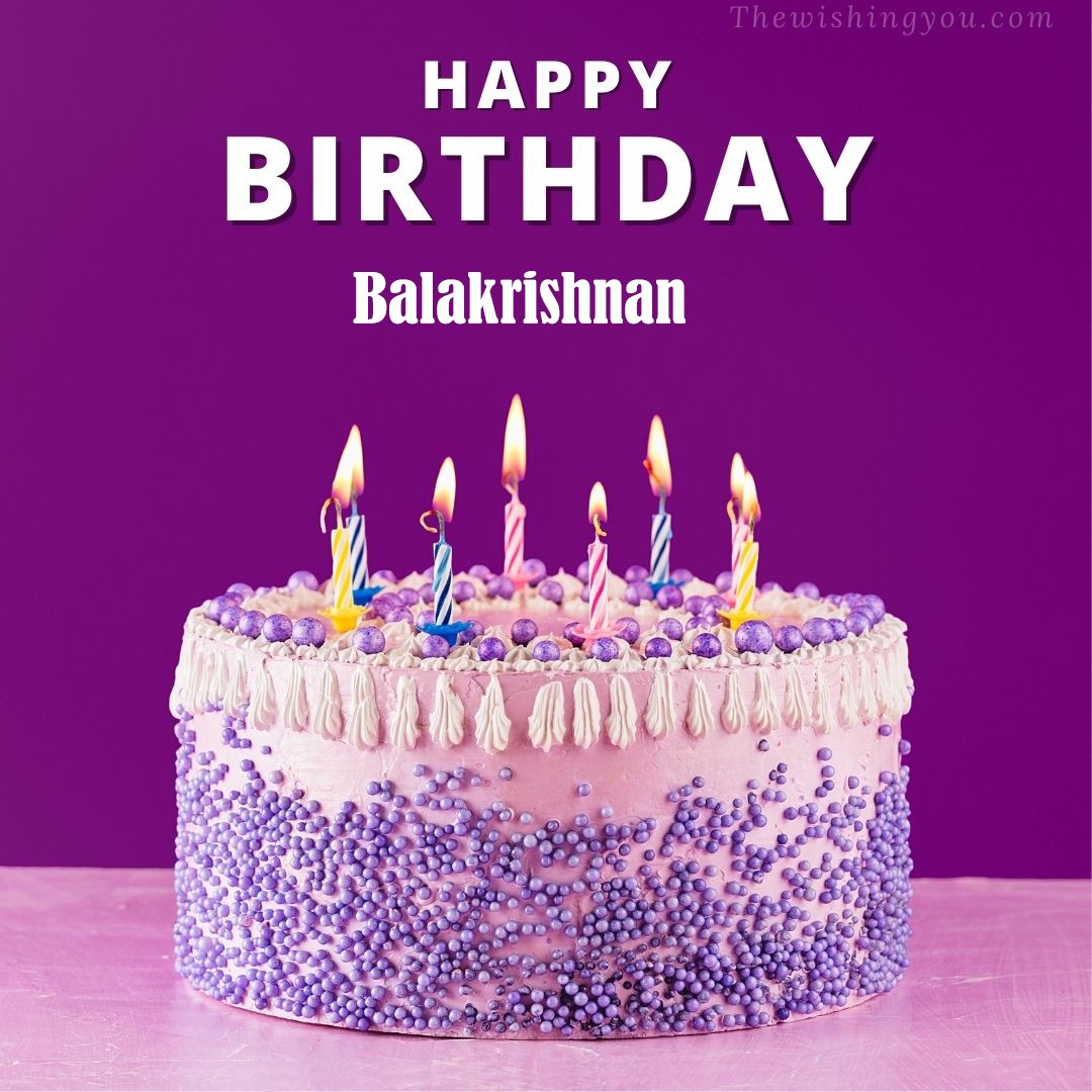 Happy Birthday Balakrishnan written on image White and blue cake and burning candles Violet background