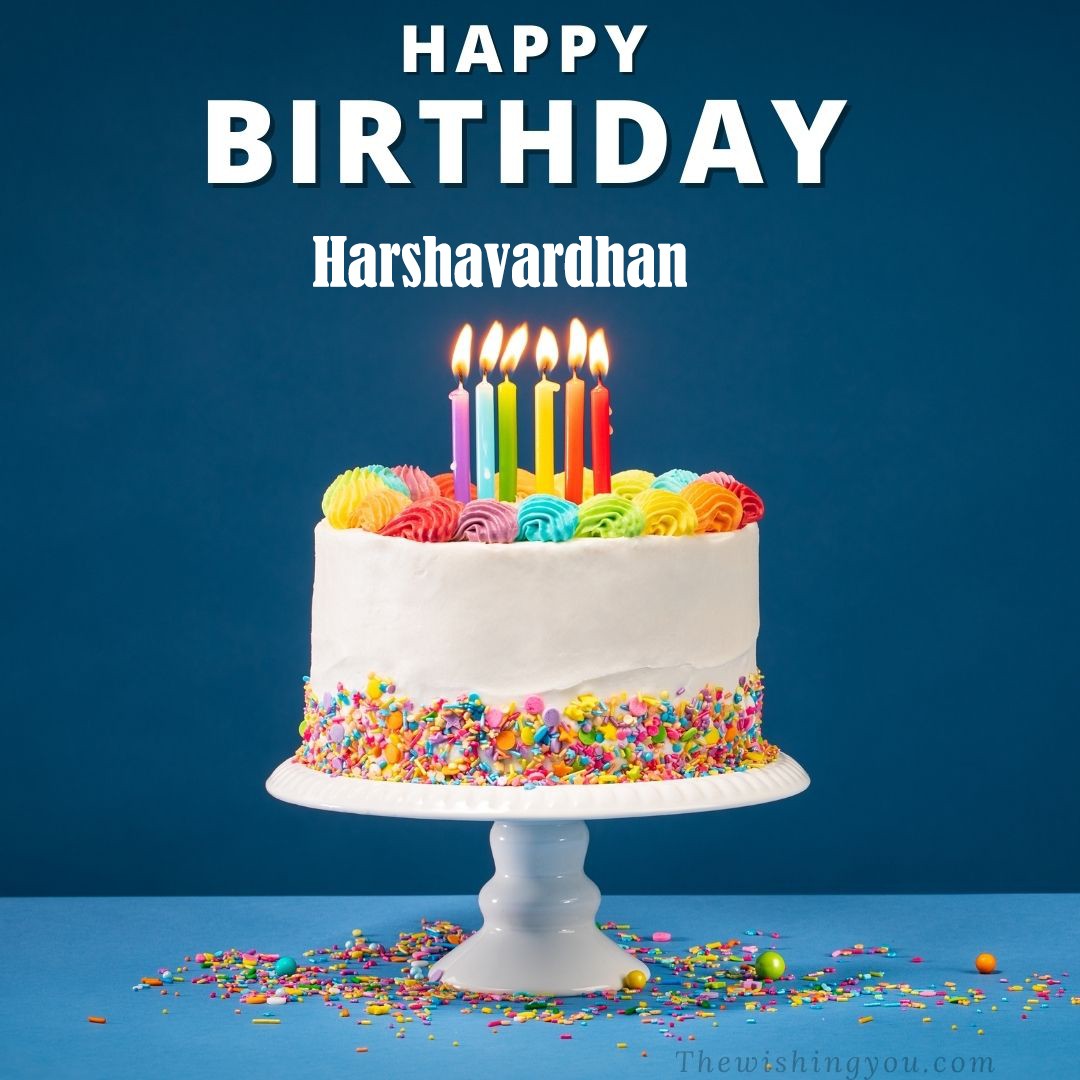 Happy Birthday Harshavardhan written on image White cake keep on White stand and burning candles Sky background