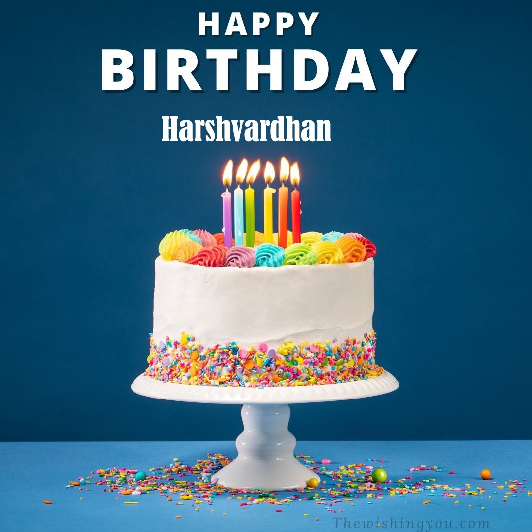 Happy Birthday Harshvardhan written on image White cake keep on White stand and burning candles Sky background