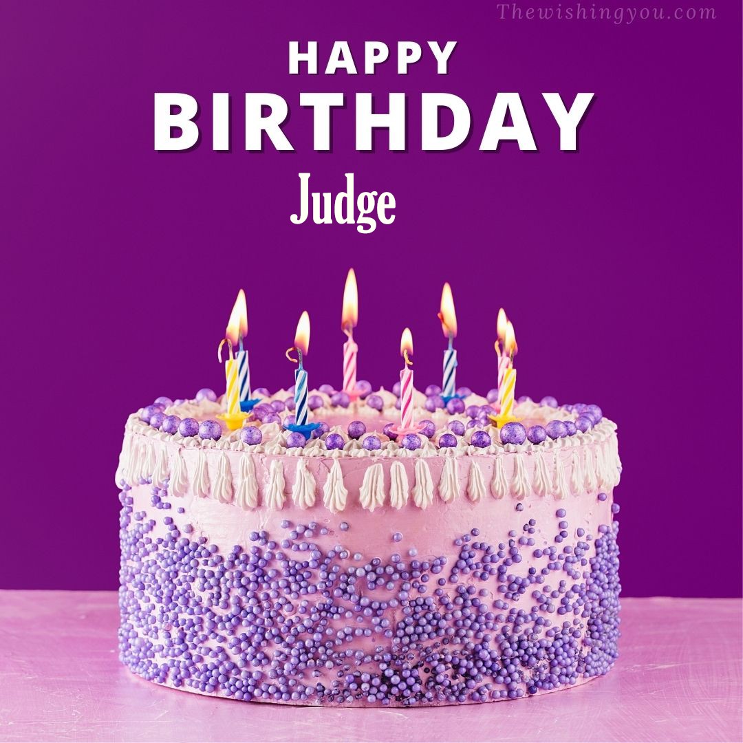 Happy birthday Judge written on image White and blue cake and burning candles Violet background