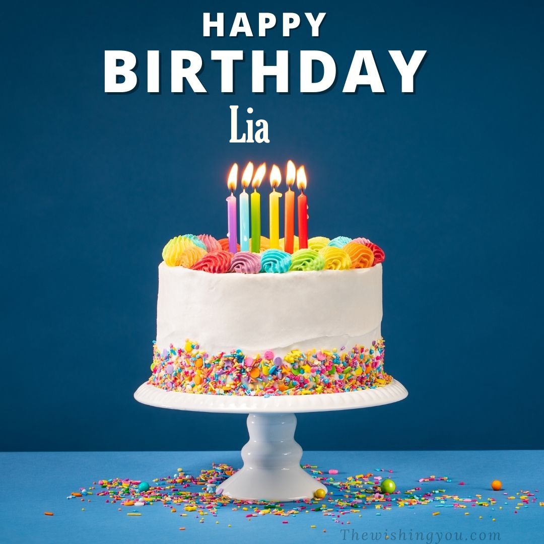 Happy birthday Lia written on image White cake keep on White stand and burning candles Sky background