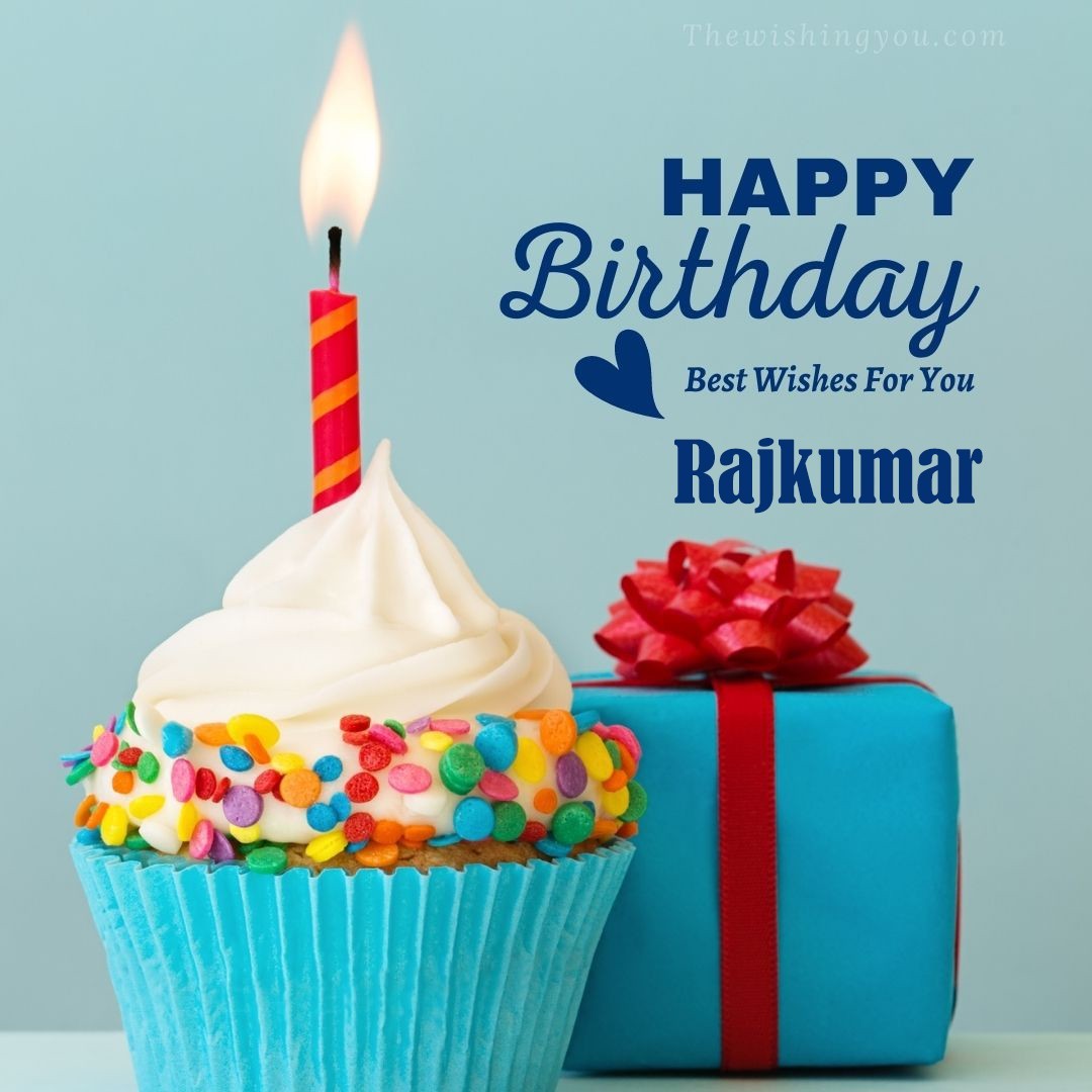 Happy birthday Rajkumar written on image Blue Cup cake and burning candle blue Gift boxes with red ribon