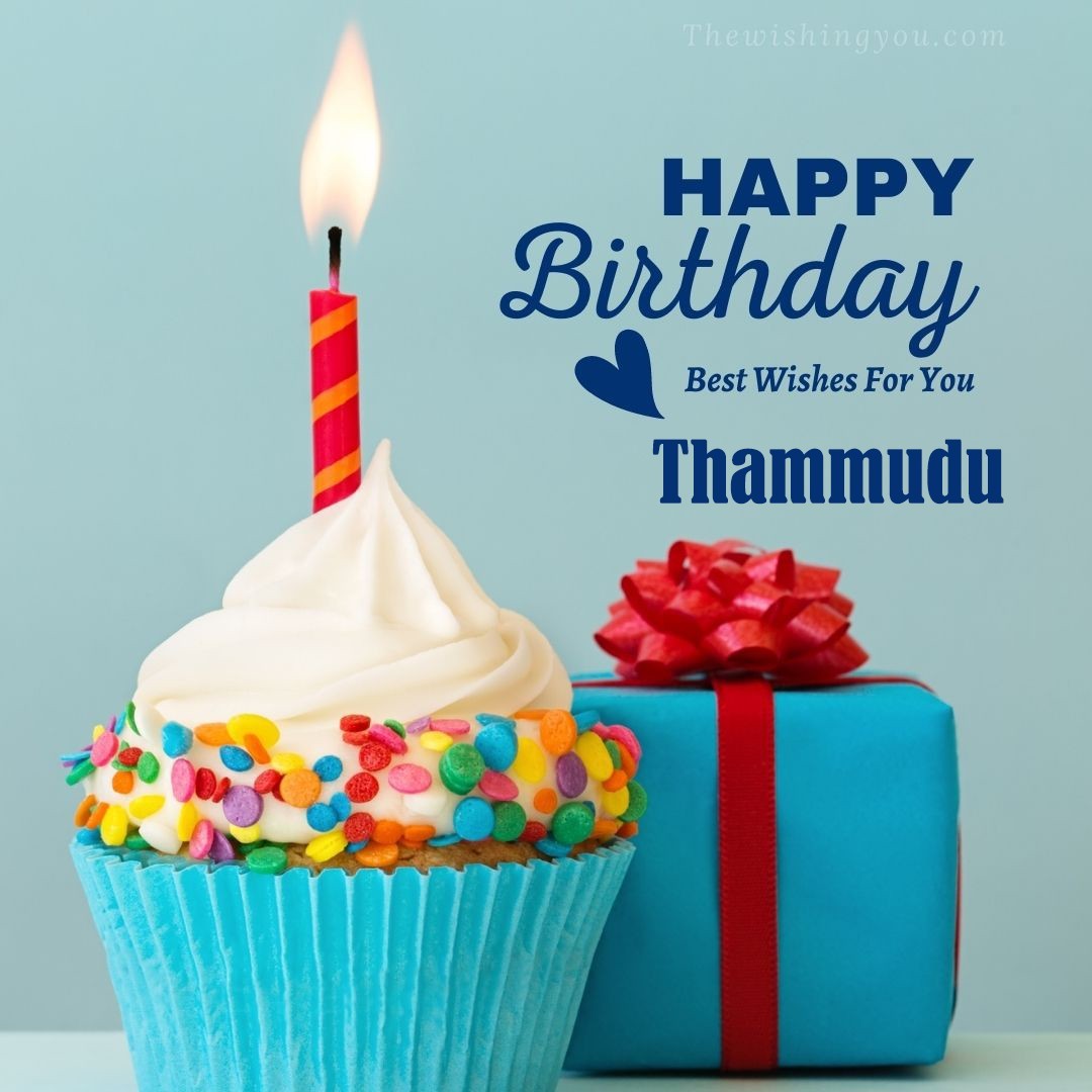 Happy birthday Thammudu written on image Blue Cup cake and burning candle blue Gift boxes with red ribon