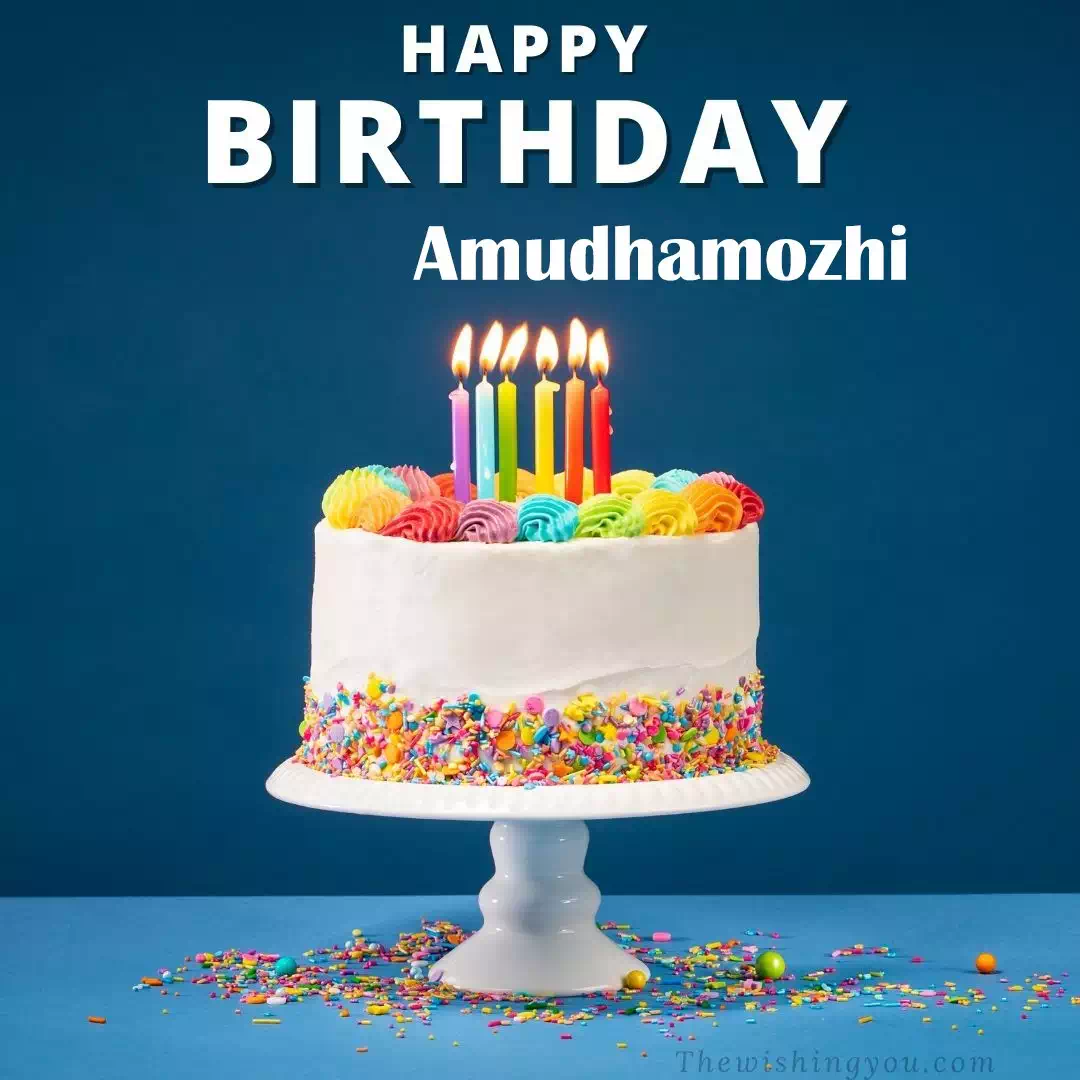 Happy Birthday Amudhamozhi written on image, White cake keep on White stand and burning candles Sky background